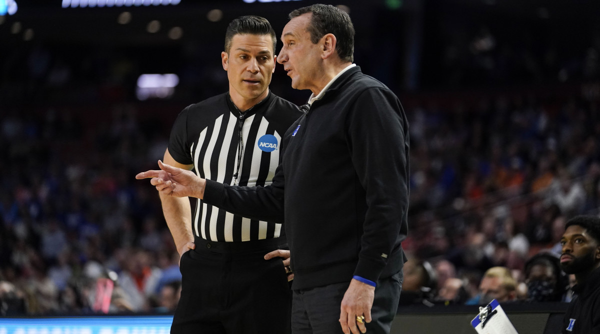 Duke head coach Mike Krzyzewski, right, talks with a referee during the first half of a college basketball game against Michigan State in the second round of the NCAA tournament Sunday, March 20, 2022, in Greenville, S.C.